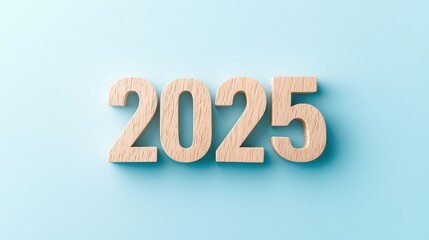 Wooden Numbers Representing the Year 2025 on a Soft Blue Background