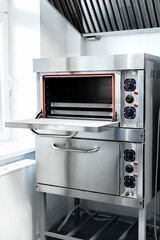 Stainless steel commercial oven in a modern kitchen ready for meal preparation