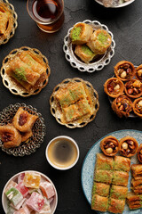 Exquisite selection of traditional Middle Eastern desserts served with tea in an elegant setting
