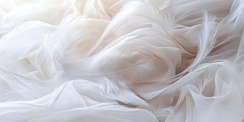 Fototapeta premium Delicate white silk feathers backdrop with soft chiffon waves and curves creating a smooth and airy texture, subtle light highlights throughout.