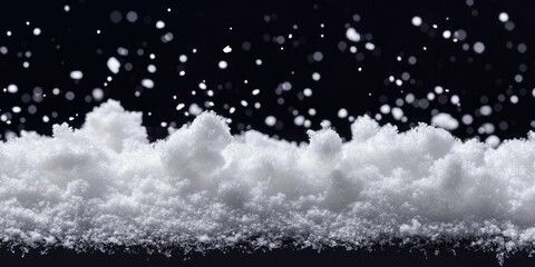 Snowy white texture layered on black background with soft snowflakes floating above creating a serene winter atmosphere in daylight.