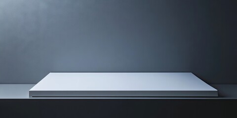 Minimalistic white tabletop on a sleek grey background with soft lighting creating subtle shadows showcasing modern design elegance