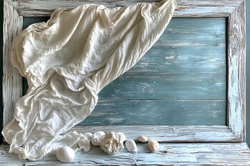 A rustic coastal still life with white fabric, seashells, and a weathered blue wooden frame.
