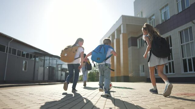Happy children walking to school. Kids with backpacks enjoying day. Group children playing and learning. Joyful kids heading to school. Excited children ready to learn. Children having fun at school.