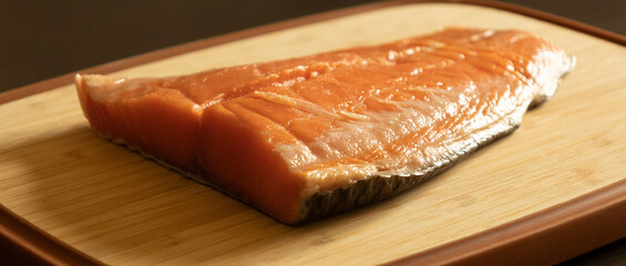 Raw Salmon Filet on Wooden Cutting Board Close-Up