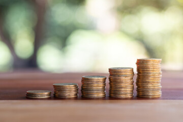 Growing money coins stack on wooden table. business, finance, investment, money saving and budget...