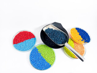 Colorful masterbatch plastic granules in transparent glass cup, polymer carrying pigment poured in...