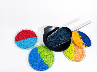 Dark blue masterbatch, polymer granules carrying pigment inside stainless steel scope, isolated on...