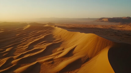 Naklejka premium Majestic Desert Landscape at Sunset: Aerial View of Golden Sand Dunes