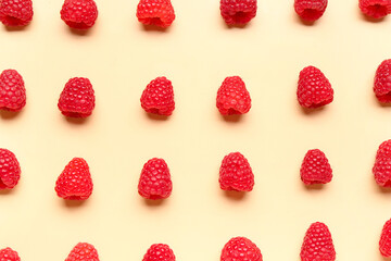 Many fresh raspberries on yellow background