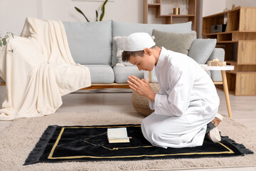 Little Muslim boy praying at home