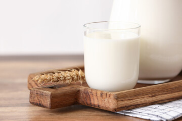 Glass of fresh milk on wooden table