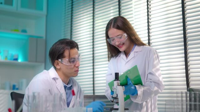 Asian male and female scientis work together in the research laboratory.
