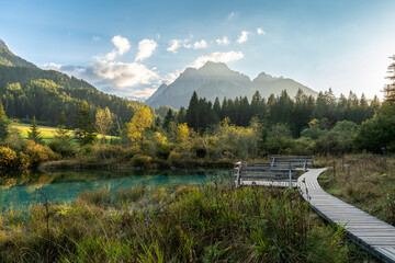 Scenic view of Zelenci Nature Reserve with emerald spring and mountains.