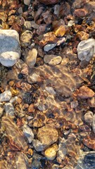Crystal Clear Waters Over River Stone Mosaic