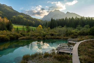 Scenic view of Zelenci Nature Reserve with emerald spring and mountains.