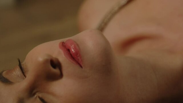 Beautiful macro of an attractive woman's lip sensually moaning in pleasure