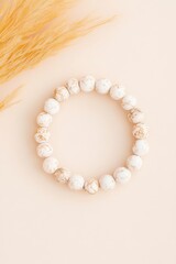 Obraz premium Elegant marble bracelet displayed on a neutral backdrop with soft textures highlighting its smooth stones and unique designs