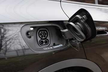 Type 2 CCS plug port on electric vehicle. DC - CCS type 2 EV charging connector at EV car. Fast...