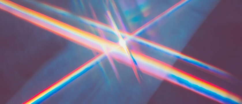 Colorful beams of light intersecting in an abstract geometric design with vibrant hues