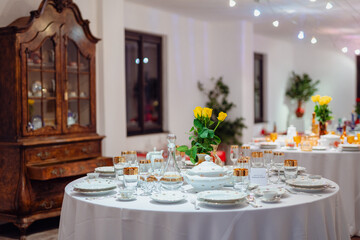 Elegant vintage dining table with porcelain and glassware in a retro style, exuding warmth and tradition