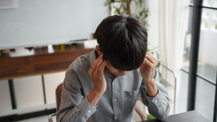 Asian business man stressed and headache office syndrome.