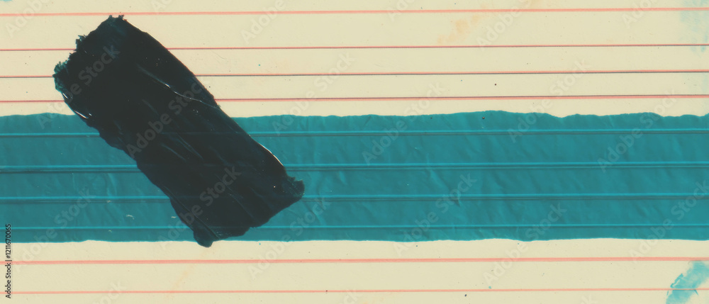 Poster ink smudges on lined paper create a creative backdrop for artistic expression