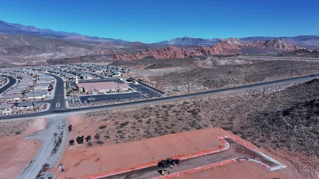 Aerial construction heavy equipment Utah overhead pull 1. ground preparation. Economic boom in housing development and subdivision. Southwestern desert Hurricane Utah. Residential homes neighborhood.