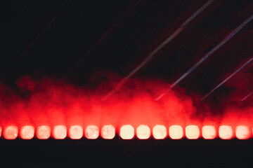 Bright red stage lights with dramatic smoke effect
