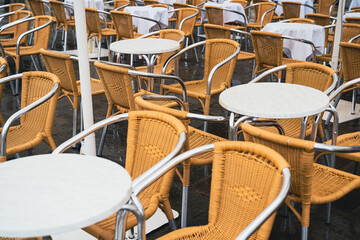Outdoor cafe chairs and tables arranged in a pattern