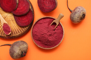 Bowl with beet powder on orange background