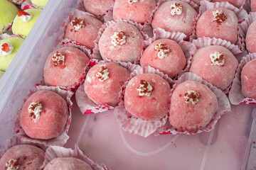 Delicious Pink Sweet Mochi Desserts with Toppings Arranged in Rows