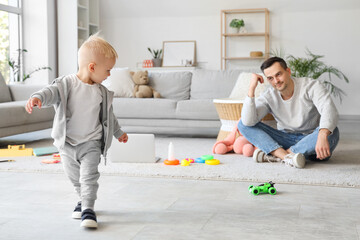 Young father and his little son at home