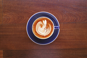  a cup of latte art coffee on wooden background                                                                                                                                                  