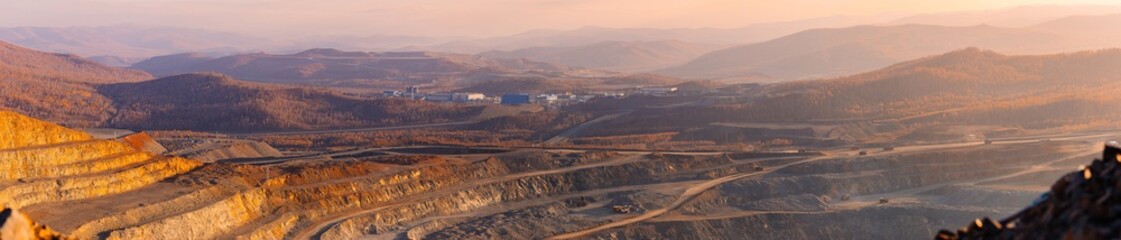 Aerial View panorama of expansive industry Open Pit Mine of ore, industrial Sunset Landscape