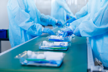 Medicine factory, sterile box production line for medical instruments and surgical kits. Workers in...