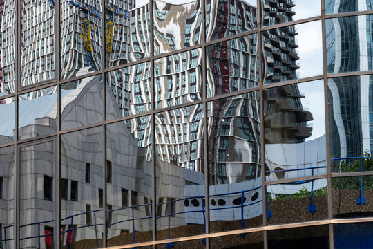 This photograph captures a stunning reflection of modern buildings, creating a captivating visual interplay of forms and light that intrigues and delights the viewer in London