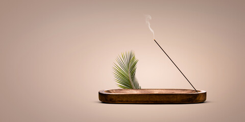 Burning incense stick in a decorative wooden holder