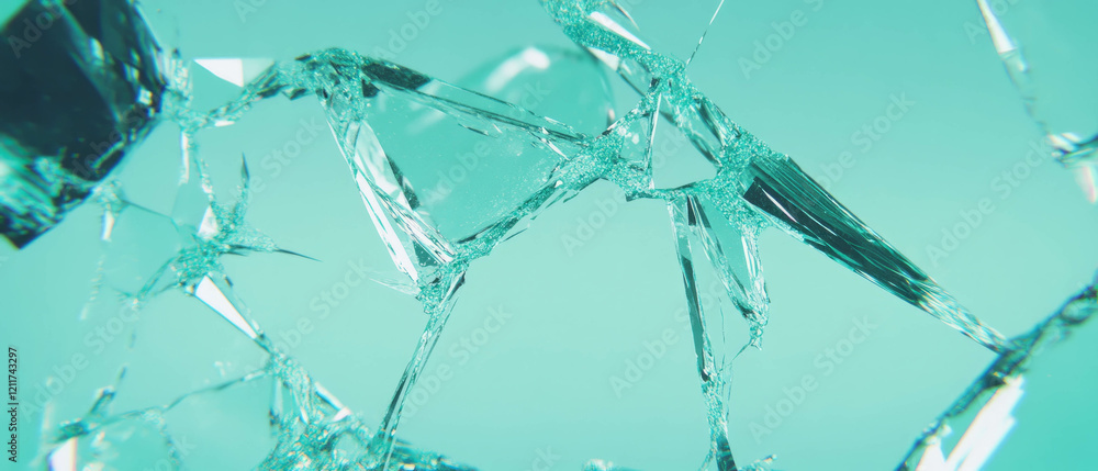 Poster shattered glass pieces creating a textured and reflective surface in soft light