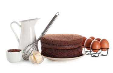 Delicious chocolate sponge cake cut into layers with ingredients and whisk on white background