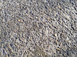Texture of old concrete with small stones. Washed concrete surface. Construction background.