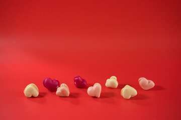 flat lay heart shape of macarons on red background