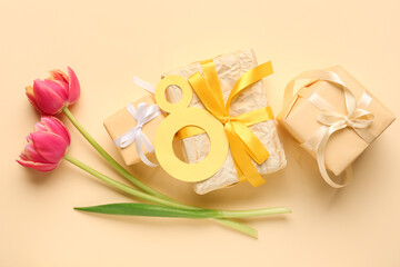 Figure 8 made of paper, tulip flowers and gift boxes on beige background. Women's Day celebration.