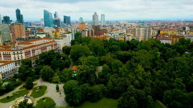 4K Aerial Drone Video of High Rise Apartment Buildings and Modern Skyscrapers near Indro Montanelli Garden Park in Milan, Italy on a Summer Day