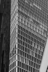 Modern architectural design featuring a grid pattern on a skyscraper in an urban environment captured during daylight