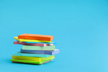 Stack of blank sticky notes on blue background