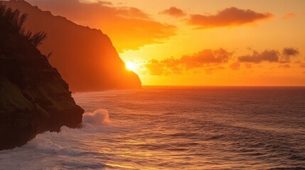 Fiery orange sunset casting light on dramatic coastal cliffs with powerful waves below
