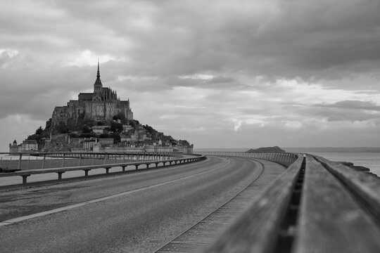 Le Mont Saint-Michel island with sheep and clouds, Normandy, France. France, Normandy, Manche department, Bay of Mont Saint-Michel.