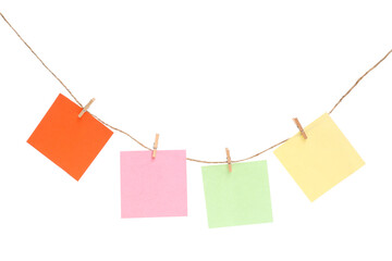 Different sticky notes, thread and clothespins isolated on white background
