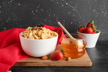 Bowl with cornflakes on black grunge background